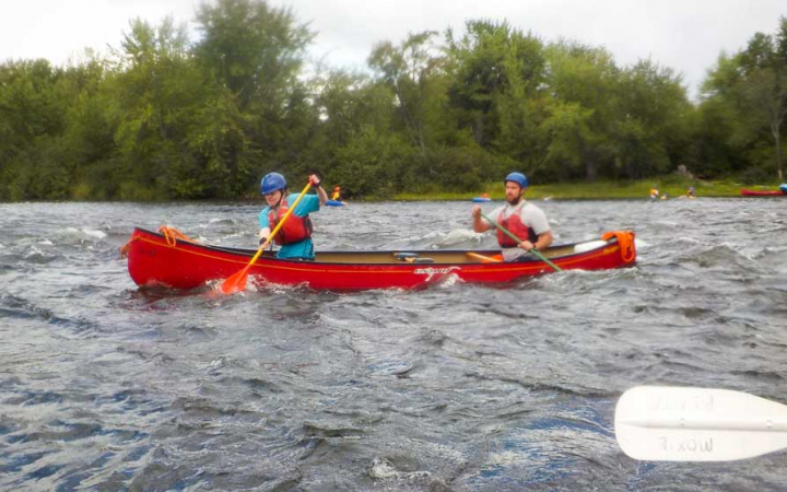two veterans navigate a canoe on an outward bound expedition